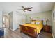 Comfortable bedroom with a ceiling fan, hardwood floors, and a large closet for ample storage at 16143 Rambling Vine E Dr, Tampa, FL 33624