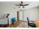 Bright bedroom featuring wood floors, a ceiling fan, and double door closet, creating a comfortable living space at 16143 Rambling Vine E Dr, Tampa, FL 33624