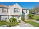 Charming two-story townhouse with well-maintained landscaping, lush greenery, and a designated parking spot at 16143 Rambling Vine E Dr, Tampa, FL 33624