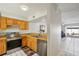 Bright kitchen featuring stainless steel appliances, wood cabinets, and an open view to the living area at 16143 Rambling Vine E Dr, Tampa, FL 33624