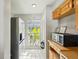 Bright kitchen area featuring a stainless steel refrigerator and a window with a garden view at 16143 Rambling Vine E Dr, Tampa, FL 33624