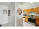Modern kitchen with stainless steel appliances and ample cabinet space, conveniently located off the entry hall at 16143 Rambling Vine E Dr, Tampa, FL 33624