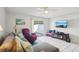 Bright living room featuring tile floors, comfortable seating, and a sliding glass door to the patio area at 16143 Rambling Vine E Dr, Tampa, FL 33624