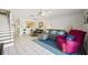 Comfortable living room with tile flooring, stairs to the upper level and a view of the adjacent kitchen at 16143 Rambling Vine E Dr, Tampa, FL 33624