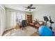 Bright home office with hardwood floors, a ceiling fan, and large windows offering natural light at 16143 Rambling Vine E Dr, Tampa, FL 33624