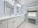 Bathroom featuring double vanity, white cabinets, quartz countertops, and tile flooring at 1664 Ridge Top Way, Clearwater, FL 33765