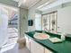 Bathroom featuring ample counter space, a shower featuring a curtain, and access to an outdoor patio at 1664 Ridge Top Way, Clearwater, FL 33765