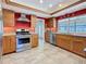 Well-lit kitchen with stainless steel appliances, light wood cabinetry, and a convenient breakfast bar at 1664 Ridge Top Way, Clearwater, FL 33765