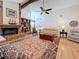 Cozy living room showcasing a brick fireplace, built-in shelving, and beamed ceilings at 1664 Ridge Top Way, Clearwater, FL 33765