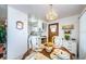 Charming dining area featuring a round table, elegant chandelier, and views into the kitchen for easy entertaining at 19 Drury Ln, Tarpon Springs, FL 34689