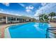 Inviting community pool with clear blue water, surrounded by lounge chairs and palm trees, perfect for relaxation at 19 Drury Ln, Tarpon Springs, FL 34689