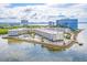 Aerial view of waterfront condominiums and pool area with city skyline in the background at 2506 N Rocky Point Dr # 358, Tampa, FL 33607