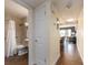 Hallway view of bathroom with tile flooring, accessible features, and a peek into the living space at 2506 N Rocky Point Dr # 358, Tampa, FL 33607