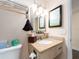 Bathroom boasts a granite countertop vanity, modern lighting, and decorative mirror at 2506 N Rocky Point Dr # 358, Tampa, FL 33607