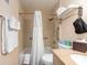 Accessible bathroom features a tub with shower, grab bars, and a granite vanity at 2506 N Rocky Point Dr # 358, Tampa, FL 33607