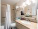 Bright bathroom featuring a shower with grab bars, granite countertop, and modern fixtures at 2506 N Rocky Point Dr # 358, Tampa, FL 33607