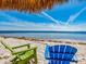 Inviting beach setting with Adirondack chairs, white sand, and clear blue water at 2506 N Rocky Point Dr # 358, Tampa, FL 33607