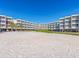 Exterior shot of a beachfront condo featuring a white sand volleyball court at 2506 N Rocky Point Dr # 358, Tampa, FL 33607