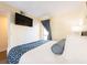 Comfortable bedroom with large bed, side table, lamp and mounted television at 2506 N Rocky Point Dr # 358, Tampa, FL 33607