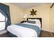 Cozy bedroom with a comfy bed, side table, lamp and large window at 2506 N Rocky Point Dr # 358, Tampa, FL 33607