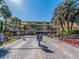 Community entrance featuring a welcome center, palm trees, and well-maintained landscaping at 2506 N Rocky Point Dr # 358, Tampa, FL 33607