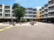Exterior view of building featuring ample parking and green space with exercise equipment at 2506 N Rocky Point Dr # 358, Tampa, FL 33607