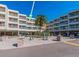 Condominium featuring an outdoor exercise area, lush landscaping, and covered parking at 2506 N Rocky Point Dr # 358, Tampa, FL 33607