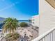 Bright and airy condominium exterior overlooking palm trees, manicured grounds and the ocean at 2506 N Rocky Point Dr # 358, Tampa, FL 33607