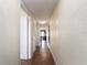 Long hallway with textured walls, tile flooring, and multiple doors leading to various rooms at 2506 N Rocky Point Dr # 358, Tampa, FL 33607