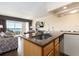 Open kitchen featuring a granite countertop, stainless steel sink, and ocean views at 2506 N Rocky Point Dr # 358, Tampa, FL 33607