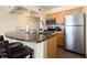 Bright kitchen featuring granite countertops, stainless steel appliances, and tile flooring at 2506 N Rocky Point Dr # 358, Tampa, FL 33607