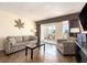 Living room showcases comfortable seating, a balcony view, and modern decor at 2506 N Rocky Point Dr # 358, Tampa, FL 33607