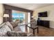 Cozy living room features stylish furniture, a TV, and a scenic ocean view from the balcony at 2506 N Rocky Point Dr # 358, Tampa, FL 33607