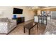 Open-concept living room with adjacent kitchen and balcony, furnished with stylish seating at 2506 N Rocky Point Dr # 358, Tampa, FL 33607