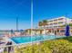 Resort-style pool featuring lounge chairs, patio tables, and adjacent condominium building at 2506 N Rocky Point Dr # 358, Tampa, FL 33607