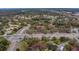 Community aerial view highlighting surrounding roadways, lush trees, and multiple building rooftops at 2650 Countryside Blvd # F209, Clearwater, FL 33761