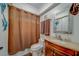 Small bathroom showcasing a single sink vanity, and a shower with a privacy curtain at 2650 Countryside Blvd # F209, Clearwater, FL 33761