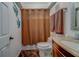 Compact bathroom with a brown shower curtain, matching towels, and a single-sink vanity at 2650 Countryside Blvd # F209, Clearwater, FL 33761