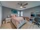 Comfortable bedroom with a ceiling fan, large bed, and a functional desk area for a modern living space at 2650 Countryside Blvd # F209, Clearwater, FL 33761