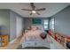 Comfortable bedroom with a ceiling fan, large bed, and bright, natural light from the windows at 2650 Countryside Blvd # F209, Clearwater, FL 33761
