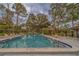 Inviting community pool featuring lounge chairs and shade umbrellas, perfect for relaxing and socializing at 2650 Countryside Blvd # F209, Clearwater, FL 33761