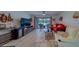 Bright living room featuring a sliding glass door to a balcony and comfortable red and white seating at 2650 Countryside Blvd # F209, Clearwater, FL 33761