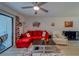 Bright living room with a sliding glass door and comfortable seating with neutral-toned floor and accents at 2650 Countryside Blvd # F209, Clearwater, FL 33761