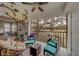 Screened-in patio offering seating, a ceiling fan, and an interesting bicycle wall decoration at 2650 Countryside Blvd # F209, Clearwater, FL 33761
