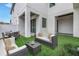 Stylish backyard patio featuring modern furniture, a lush green lawn, and a covered outdoor seating area at 2810 N Massachusetts Ave, Tampa, FL 33602