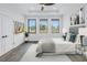 Serene bedroom with modern decor, large windows offering natural light, and stylish gray accents at 2810 N Massachusetts Ave, Tampa, FL 33602
