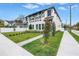 Beautiful modern two-story home with a well-manicured lawn, stylish black accents, and a welcoming paved walkway at 2810 N Massachusetts Ave, Tampa, FL 33602