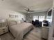 Comfortable bedroom featuring neutral tones, ceiling fan, and a functional desk area at 3497 Birchwood Ct, Palm Harbor, FL 34684