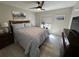 Inviting bedroom with patterned bedding, light wood floors, and a view to the outside at 3497 Birchwood Ct, Palm Harbor, FL 34684