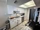 Efficient kitchen with stainless steel appliances, bright lighting, and ample cabinet space at 3497 Birchwood Ct, Palm Harbor, FL 34684